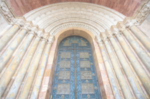 Blue church door flanked by columns.